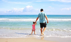 father and child on beach